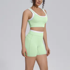 Close-up detail of the light green and white color-blocked sports bra and shorts.