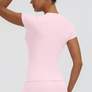 Close-up back view of women pink short sleeve slim yoga fitness top, breathable fabric.