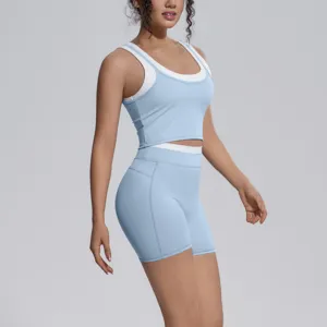 Stylish color-blocked women yoga set crop top and tight shorts for fitness running gym.