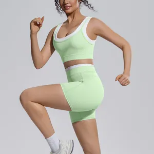 Close-up detail view of the light green and white color-blocked sports activewear set.