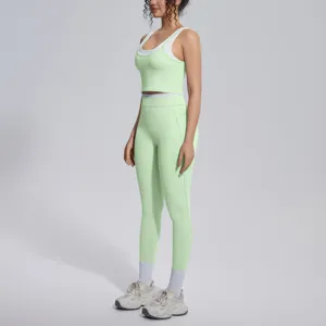 Detail shot of light green ribbed activewear set, showing form-fitting crop top and leggings.