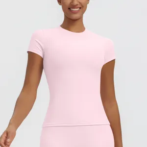 Detail view of the pink short-sleeve fitness top, breathable stretch fabric for workouts.