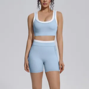 Detail shot of light blue colorblocked yoga set, nylon nude fabric, sports bra & shorts.