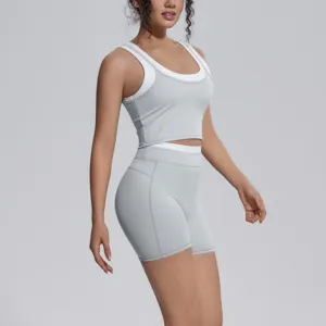 Detailed view of women's athletic yoga set featuring breathable layered tank and shorts.
