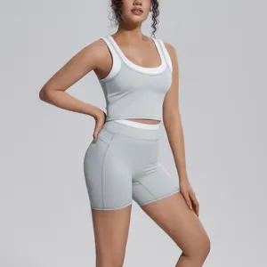 Close-up detail of contrast color yoga set, breathable ribbed tank and shorts for fitness.