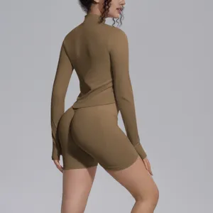 Solid brown seamless long sleeve crop top and biker shorts activewear set for women.