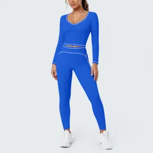 Detailed view of royal blue long sleeve yoga crop top and leggings set with stylish white piping.