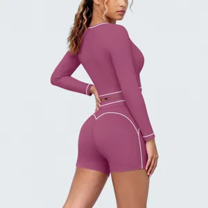 Detailed view of the contrast trim activewear set featuring a long sleeve crop top and shorts.