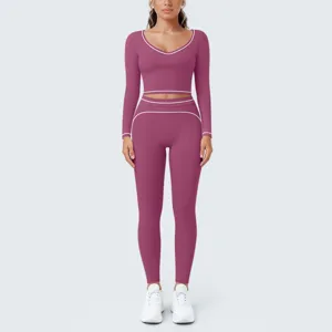 Detailed view of women's contrast piping long sleeve crop top and yoga leggings set.