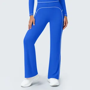Blue high-waist yoga pants detail view, flared trousers with contrast piping design.