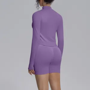Seamless purple long sleeve athletic top and shorts set for fitness running yoga workout gym.