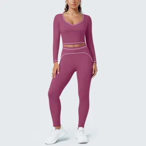 Detail view of the maroon long-sleeve crop top and matching leggings with white trim.