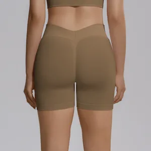 Close-up back view of brown seamless high-waist V-waist peach-lift yoga shorts and sports bra.