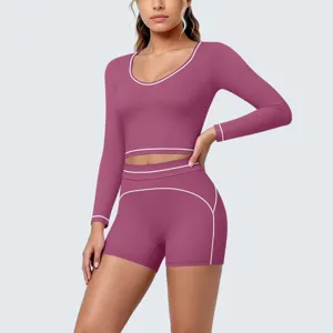 Women's contrast trim long sleeve crop top and high waist sports shorts yoga two-piece set.