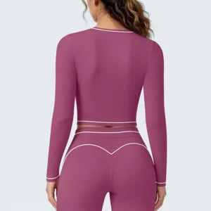 Dames sport lange mouw crop top en legging fitness yoga set met contrasterende bies.