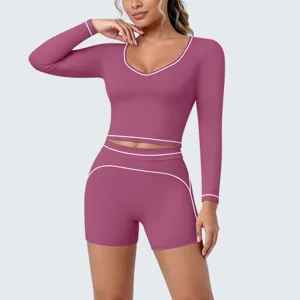 Close-up details of the contrast-trimmed long sleeve crop top and shorts workout set.