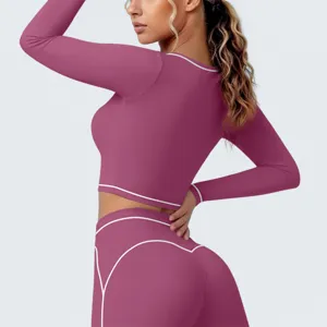 Nahaufnahme Detail des Sport Langarm Crop Tops mit Kontrastpaspelierung und Leggings.
