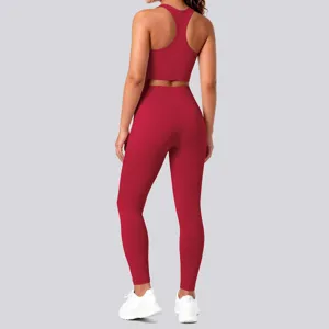 Solid color athletic yoga set detail featuring backless sports bra and high waist leggings.