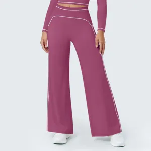 Detailed view of high-waist wide-leg athletic pants with contrast piping and matching top.