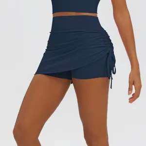 Detail shot of navy blue athletic skort with side ruching and built-in shorts for yoga.