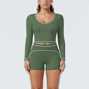 Green contrast piping long sleeve crop top and shorts yoga set for workout and fitness.