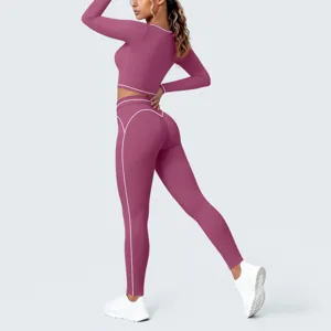 Detail view of women's seamless athletic yoga crop top and leggings set with contrast piping.