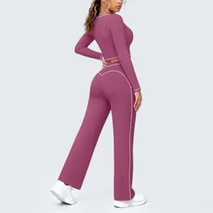 Detailansicht des langärmligen Crop-Tops mit Kontrastbündchen und der weiten Yogahose.