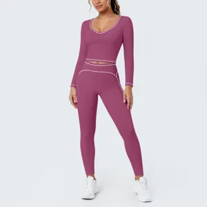 Close-up details of women contrast piping long sleeve crop top and yoga leggings set.