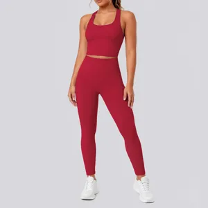 Red seamless two-piece yoga set featuring a scoop neck sports bra and high-waisted leggings.