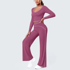Detailansicht des passenden Langarm-Crop-Tops und der Schlag-Yogahose mit Paspelierung.