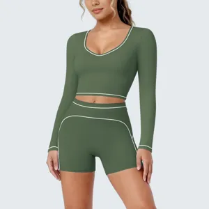 Olive green long sleeve crop top shorts yoga set detail view showing contrast piping.