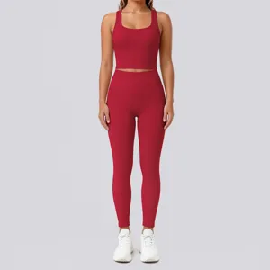Solid red two-piece yoga set featuring a scoop neck crop top and high-waisted leggings.