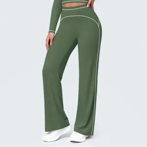 Detail view of the green high-waist wide-leg yoga pants featuring stylish white piping.