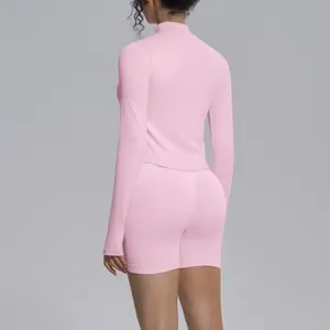 Back detail view of pink seamless long sleeve top and matching tight shorts fitness yoga set.