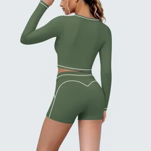 Detail view of green athletic crop top and shorts featuring stylish white contrast piping edges.