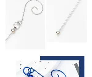 Close-up details of metal Christmas tree hanging hooks featuring beaded spiral designs.