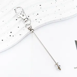Silver metal DIY keychain with lobster clasp and cone bullet rod charm for bags.