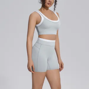 Close-up detail of grey and white contrast sports bra and shorts yoga set for workout fitness.