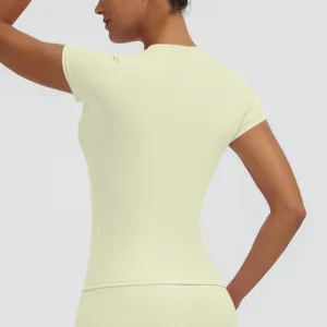 Detail view of women slim short sleeve yoga top, light yellow fitness running activewear.