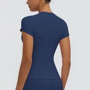 Back view detail of women slim-fit short sleeve athletic t-shirt in solid dark blue.