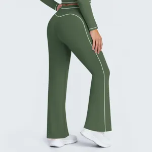 Dark green athletic flare pants detail view, high waist design with white contrast piping.