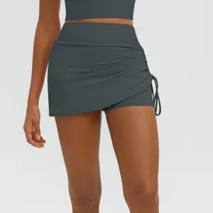 Close-up detail of high-waist ruched athletic skort in dark grey, breathable yoga shorts.