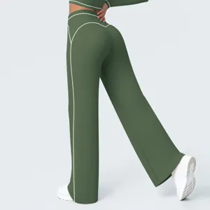 Detail view of women's high waist wide leg yoga pants in green with white piping accent.
