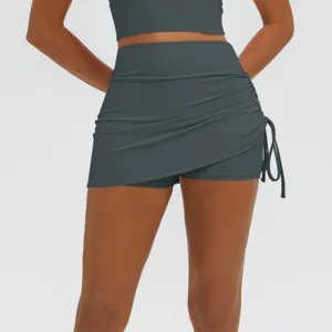 High waist ruched athletic yoga skirt with built-in shorts for women running fitness wear.