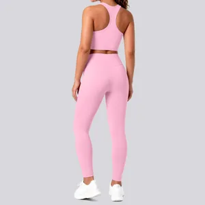 Pink seamless yoga set featuring a racerback sports bra and high waisted leggings for fitness.