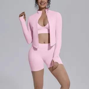 Pink seamless activewear detail shot, long sleeve zip jacket, sports bra and shorts set.