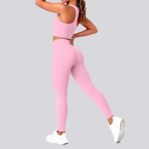 Pink seamless ribbed sports bra and high waist yoga leggings set activewear detail view.