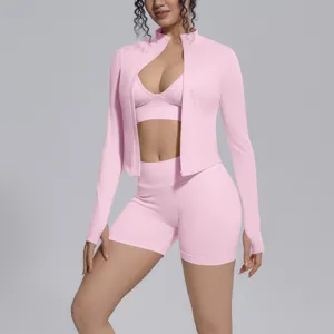 Seamless solid pink 3-piece sports yoga set featuring zip jacket, bra and shorts for fitness.