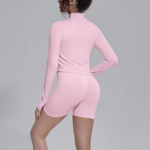 Pink seamless long sleeve sports top and shorts detail, high elastic fitness yoga wear.