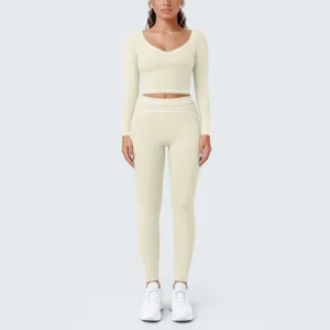 Women solid color long sleeve crop top matching fitness leggings activewear set detail view.